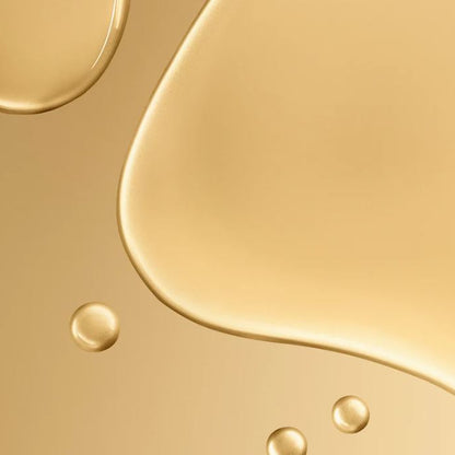 Close-up of gold liquid texture with droplets on a gold background