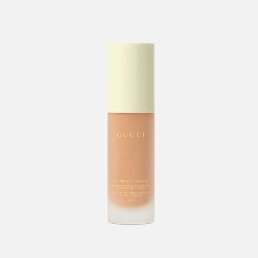 Gucci skincare bottle on a light beige background