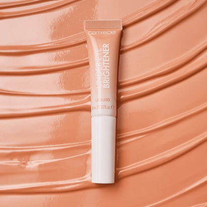 Catrice highlighter tube on a peachy background