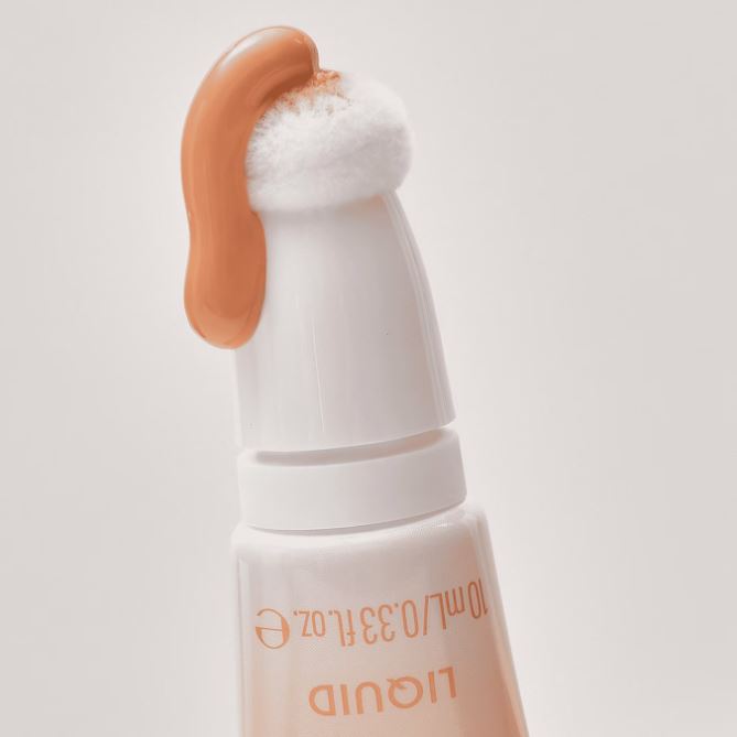 Cosmetic product with a applicator on a light gray background