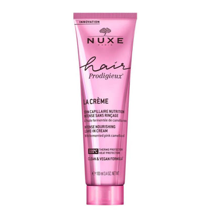 Pink tube of Nuxe hair product on a white background