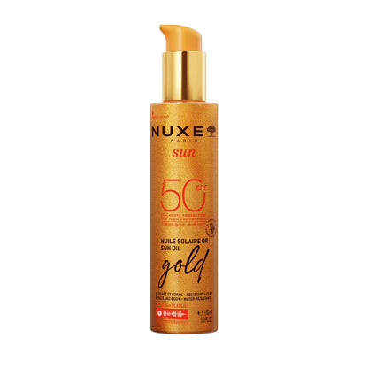 Nuxe sun oil bottle with gold cap on a white background