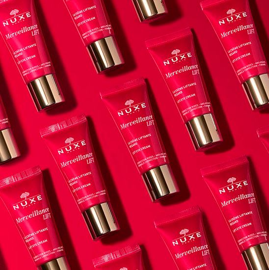 Multiple Nuxe Merveillance Lift skincare products on a red background