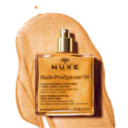 Nuxe Huile Prodigieuse Or bottle on a gold background