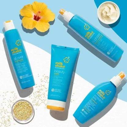 Milk Shake Sunscreen products on a light blue background with flowers and small containers.