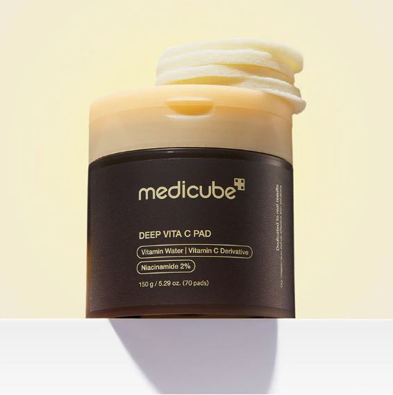 Jar of Medicube Deep Vita C Pad on a light yellow background