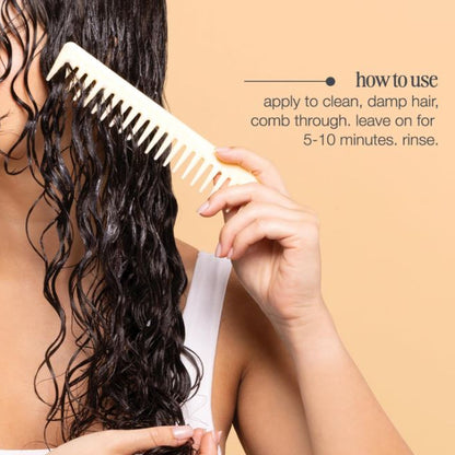 Person using a white comb on wet hair with instructions on a beige background