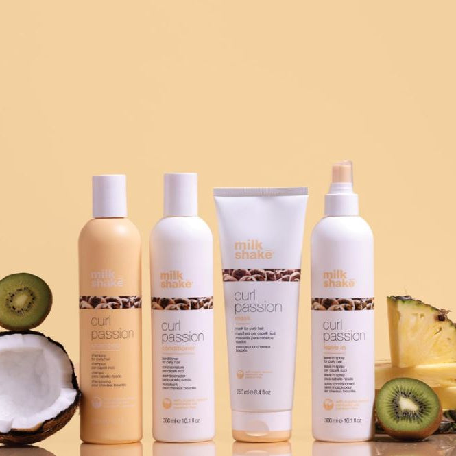 Set of 'milk shake' hair care products with fruits on a beige background