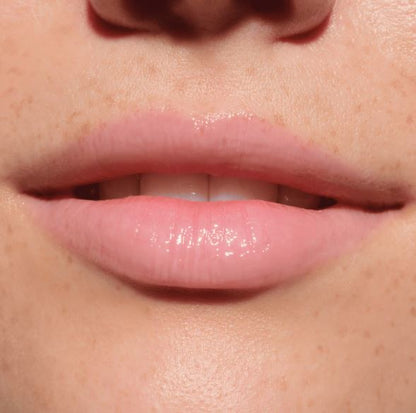 Close-up of a person's lips with a glossy lip product