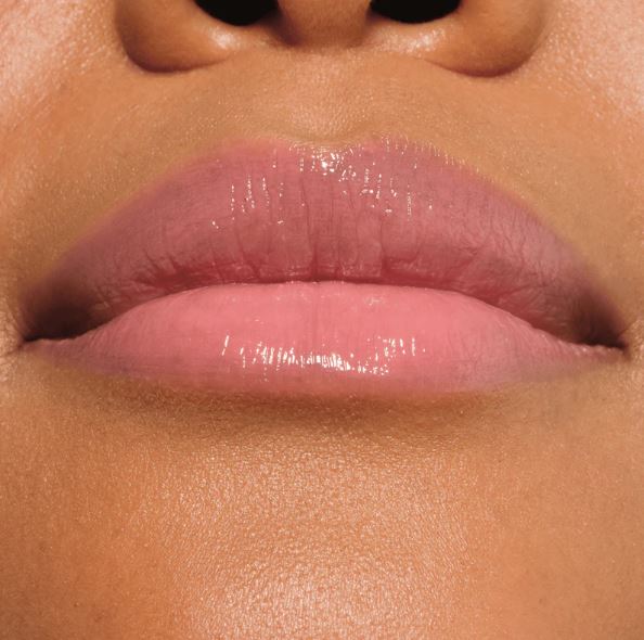 Close-up of a person's lips with a glossy lip product