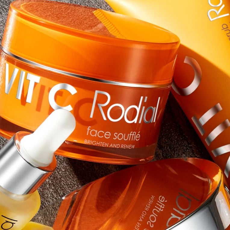 VITIC Rodial skincare products including a jar, dropper, and bottle on a textured surface.