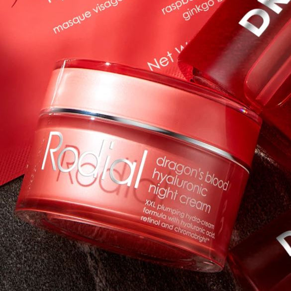 Red jar of Radial dragon's blood hyaluronic night cream with packaging in the background.