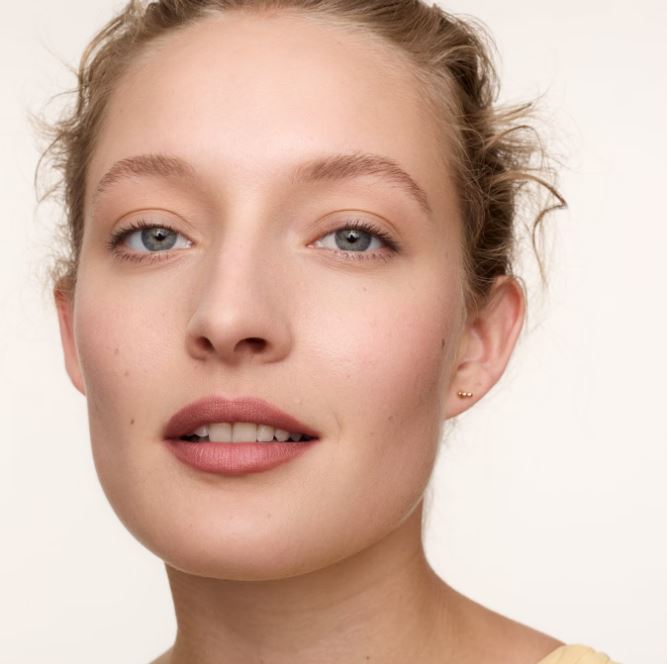 Close-up of a woman's face with a neutral background