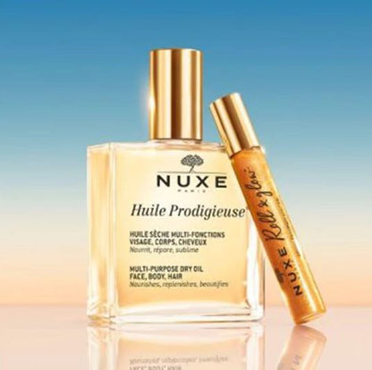 Nuxe Huile Prodigieuse multi-purpose dry oil with a smaller rollerball bottle on a gradient background