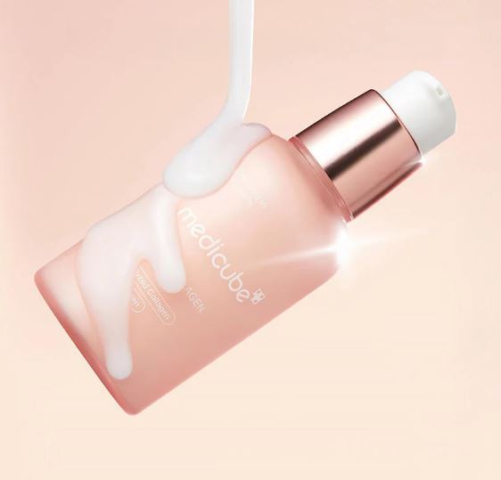 Skincare product with a pink bottle and white cap on a light pink background