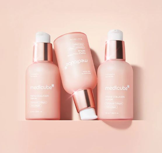 Four skincare products from Medicube on a pink background
