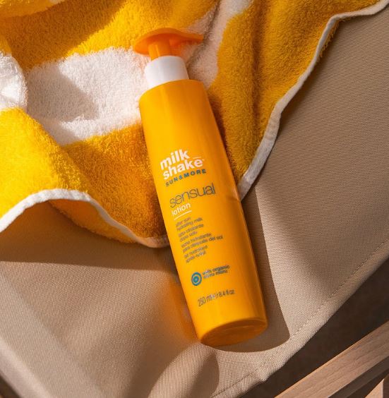 Orange bottle of Milk Shake Sensual lotion on a yellow towel