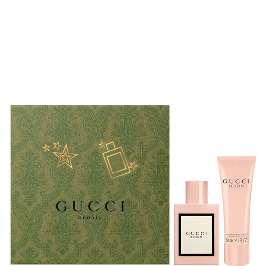 Gucci beauty set with green box, pink perfume bottle, and lotion on a white background