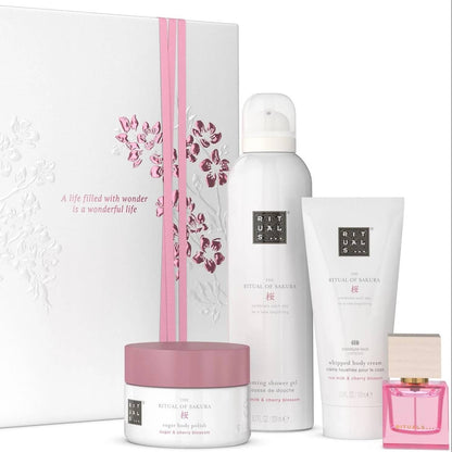 Set of skincare products including a jar, bottle, and other items with a decorative box on a white background.