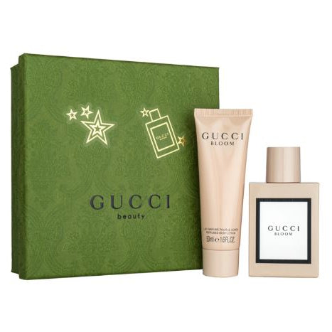 Gucci beauty set with green box, tube, and bottle on a white background