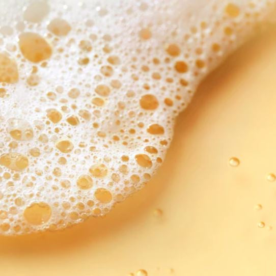 Close-up of a creamy yellow liquid with bubbles