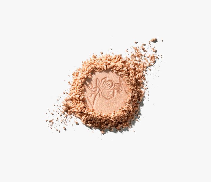 Pile of beige makeup powder with a brand logo on a white background