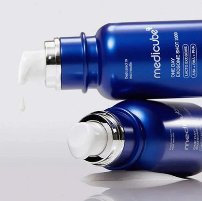 Two blue bottles of Medicube skincare product on a light gray background