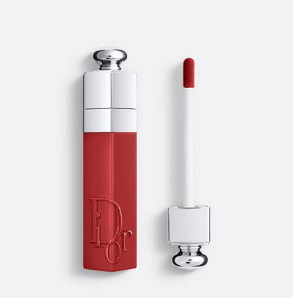 Red Dior lip gloss with silver cap on a white background