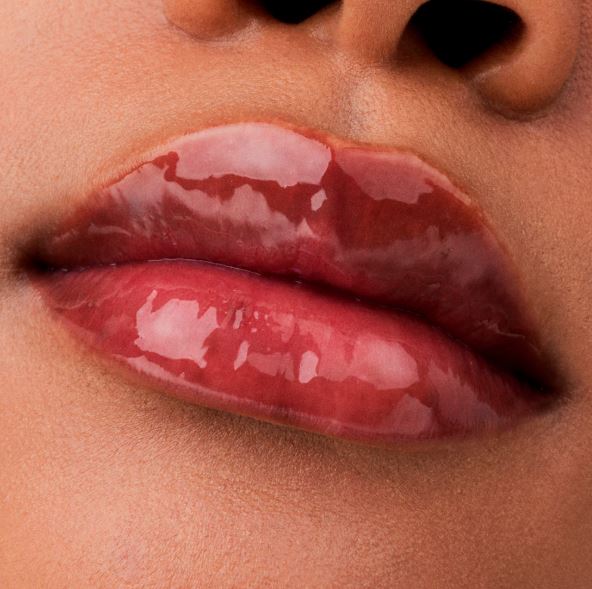 Close-up of glossy red lips with a focus on texture and color.