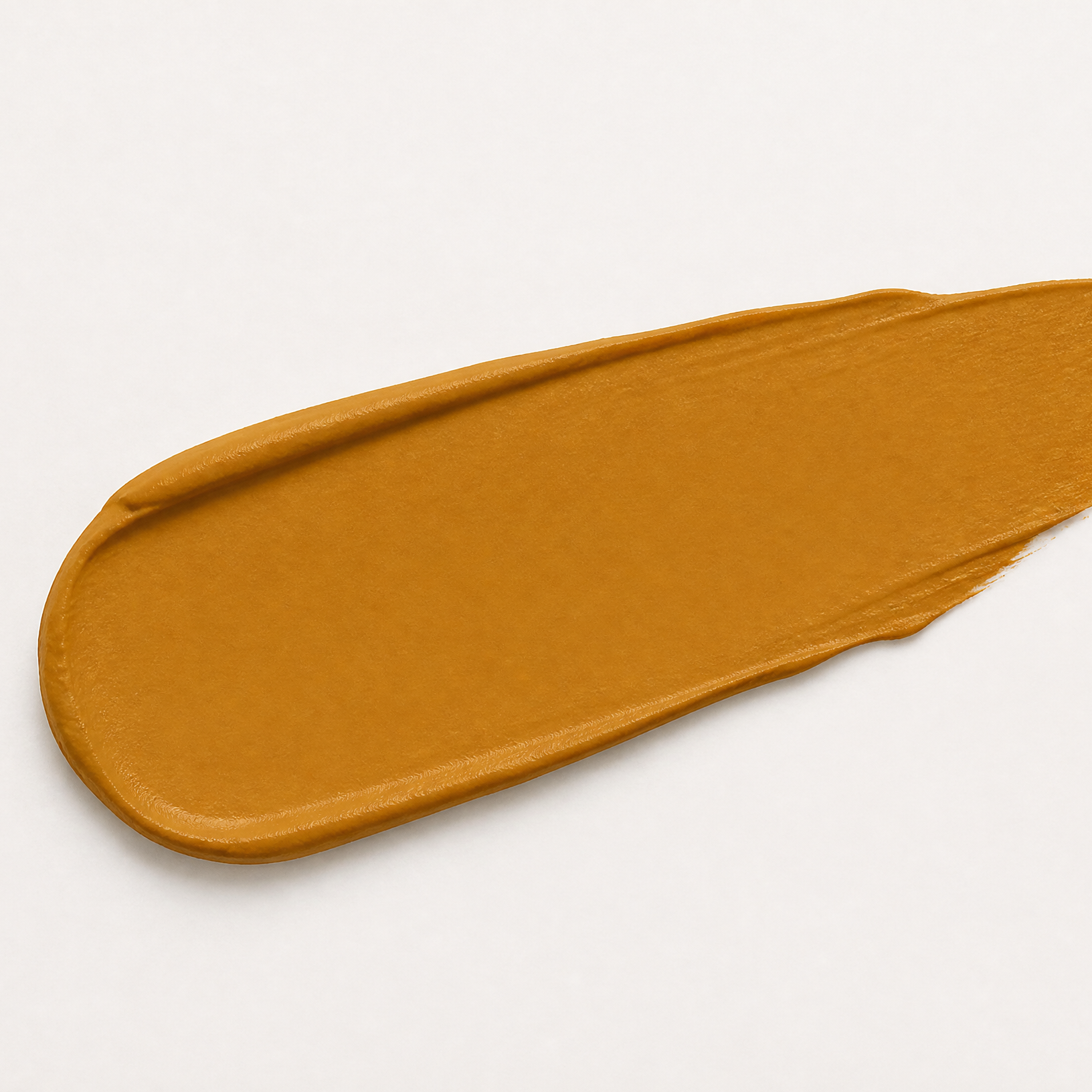 Mustard yellow paint swatch on a light gray background