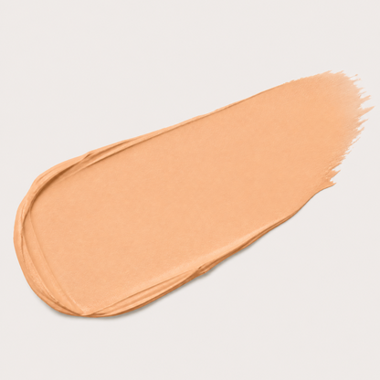 Nude-colored makeup swatch on a light gray background