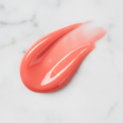 Pink lip balm smear on a marble surface