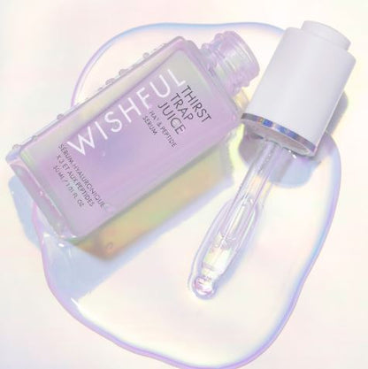 Skincare serum bottle with dropper labeled 'Wishful' on a reflective surface.