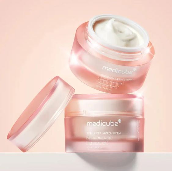 Two jars of Medicube cream on a light pink background