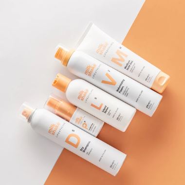 Set of skincare bottles with visible brand names on a white and orange background