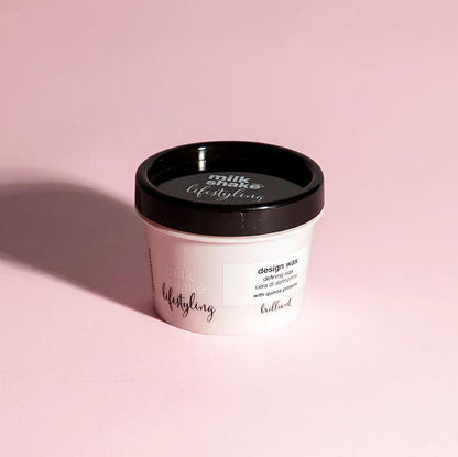 Container of milkshake styling wax on a pink background